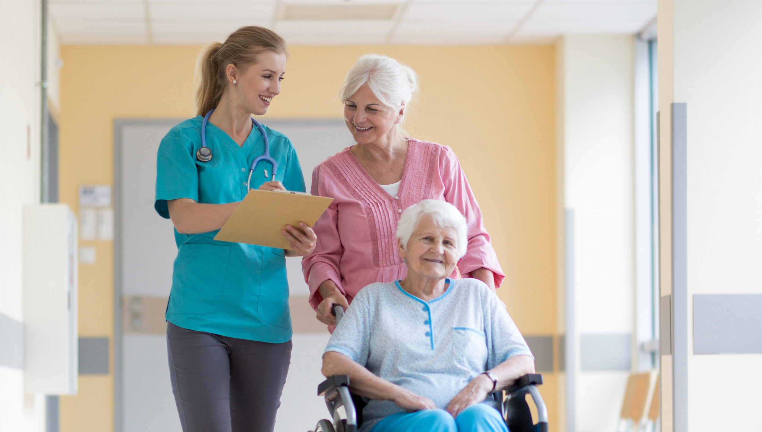 Elderly,Woman,On,Wheelchair,With,Her,Daughter,And,Nurse